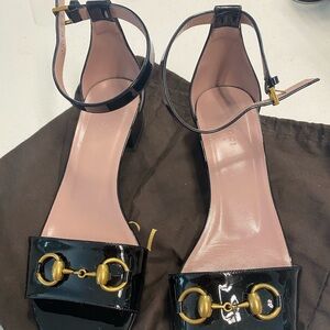 Barely worn black gucci flat patent leather sandals.